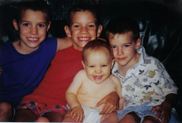 My four boys, summer 2000. Note the very dark tan hand around the baby's middle. 