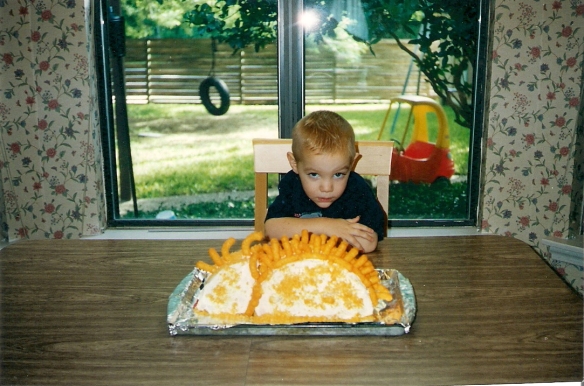 Age three, SM wanted a dinosaur cake. His parents made one with Cheetos... His first (but not last!) Cheesy-Puffasaurus birthday cake